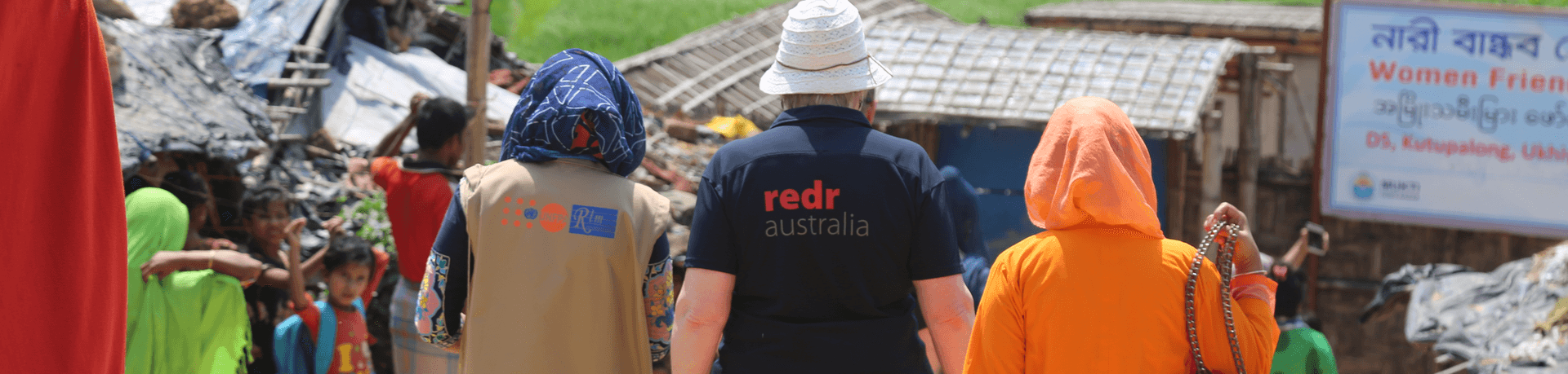 A RedR Australia specialist walking alongside community members